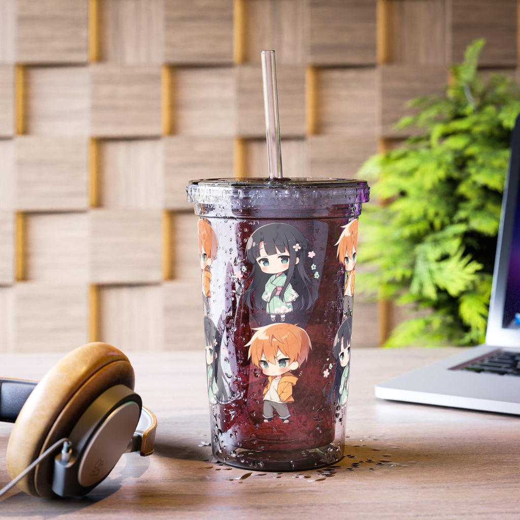 Tumbler with anime character design on a desk with headphones and a laptop.